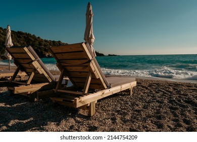 Empty Sunbeds On Beach No People