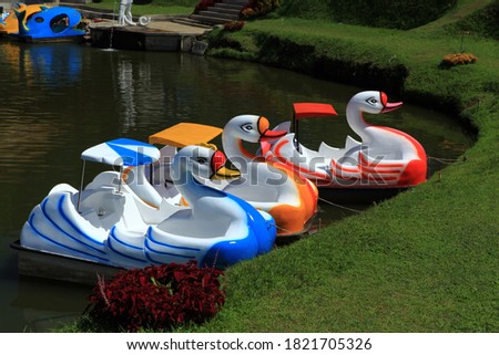 Empty swan pedal boats floating on the lake in a park