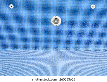 An Empty Swimming Pool With Blue Tiles