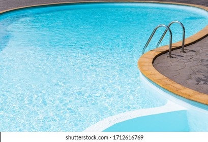Empty swimming pool with blue water and stair on shape curve
