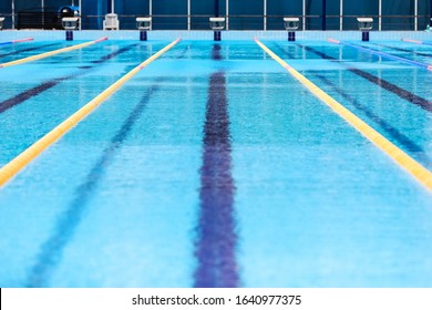 Empty Swimming Pool With Competition Lanes. Texture Of Classic Blue Water. 