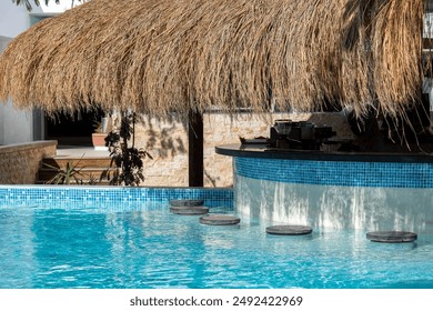 Empty Swim-Up Bar with Straw Canopy in Tropical Resort