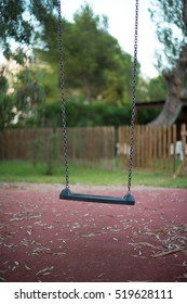 Empty swing in the backyard.