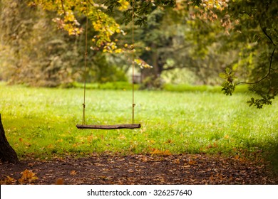 Empty swing placed in the garden