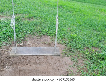 Empty swing placed in the garden with copy space - Shutterstock ID 689136565