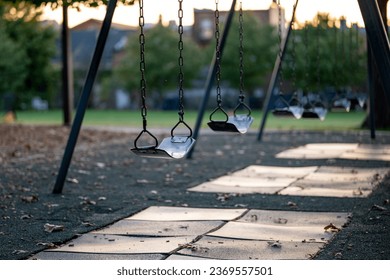 Empty Swing at a Playground at Sunset