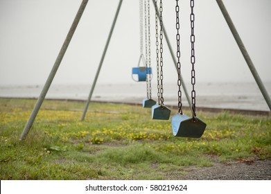 Empty Swing Set On Gloomy Day