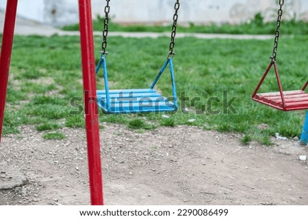 Empty swings in the playground 