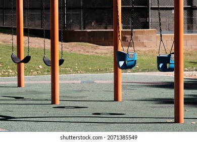 An empty swingset on a sunny playground