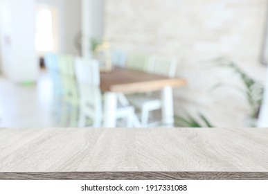 empty table board and defocused modern kitchen dining table background. product display concept