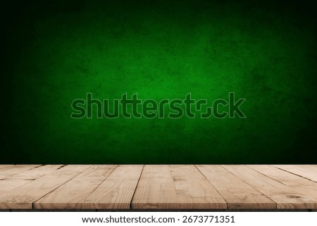 Empty table and darkgreen wall. Table with sun reflections and leaves shadows on beige wall. Background with bokeh for product presentation.Mock up for presentation, branding products, cosmetics food 