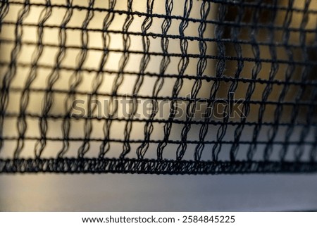 empty table with grid black mesh tabletennis, table tennis net in a blue ping pong table. standard ping pong table has a net stretched across the middle. games for office workers to have fun.