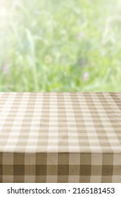 An Empty Table With A Napkin. Blurry Summer Or Spring Background