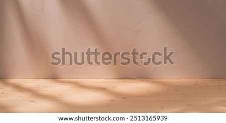 Empty table on beige texture wall. Stylish panoramic background with sun lights and deep shadows. Product presentation wood board.