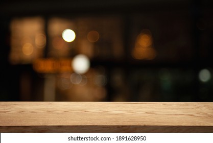 Empty Table On Dark Background With Blurred Lamps, Cafe Restaurant Bokeh For Your Product Or Customization