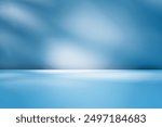  Empty table on smooth blue wall background. Composition with abstract light reflections and shadows. Mock up with blurry spotlight for winter presentation, branding products, cosmetics and food.