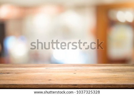 Empty table for present product with blured background of coffee cafe.