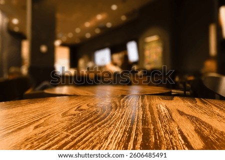 EMPTY TABLE WITH RESTAURNT BACKGROUND, DESIGN FOR MONTAGE FOOD AND DRINK WITH BLURRY INTERIOR AND LIGHTS