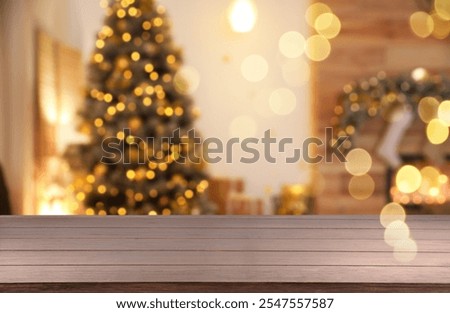 Empty table in room with Christmas tree, bokeh effect
