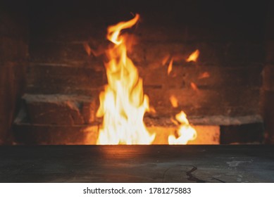 Empty table surface with copy space on burning fire background. - Shutterstock ID 1781275883