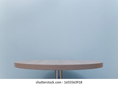 Empty table top on blue wall background with copy space.
