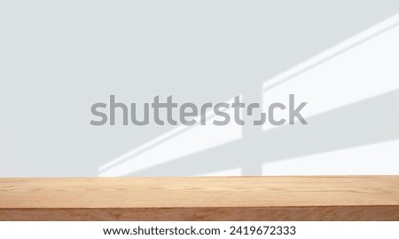 empty table with window shadow on light wall background for product mockup display. kitchen interior theme