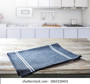Empty tablecloth on wooden deck table with napkin top view mockup. Kitchen background.