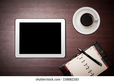 empty tablet and a cup of coffee on the desk