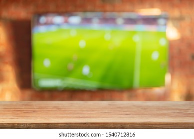 Empty Tabletop On Brick Wall Background With Tv