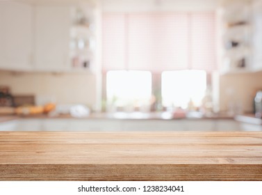 Empty tabletop over defocused kitchen with copy space