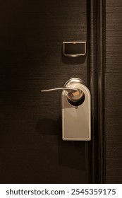 Empty tag in  do not disturb sign hanging on elegant hotel room door