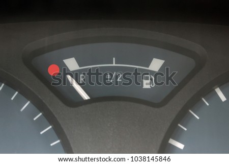 Empty tank indicator on car dashboard. Concept - economic crisis, deficit, lack of money, lack of strength and health, fatigue, fuel consumption. 