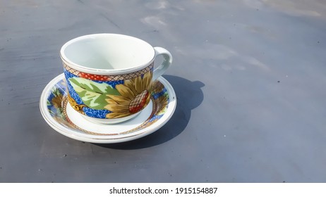 Empty teacup on gray background