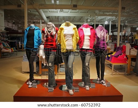An empty teenage fashion store with five mannequin displaying the latest trend with jeans, hoodies, t-shirts and scarfs.
