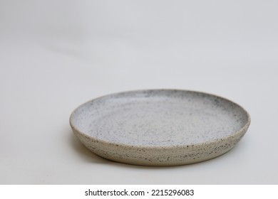 Empty textured plate on white background, isolated