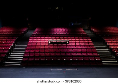 Empty Theater With Red Chairs At A Musical Stage, Before Or After An Audition.