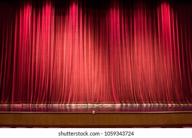 Empty Theatre Stage And Red Curtain Or Drapes Background.