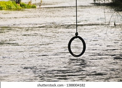 Empty Tire Swing On Nature River