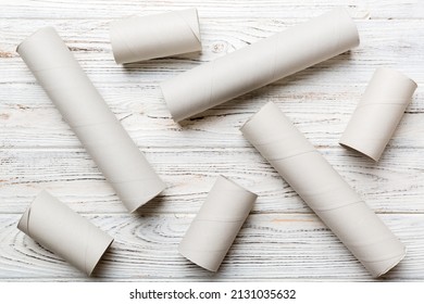 Empty toilet paper roll on colored background. Recyclable paper tube with metal plug end made of kraft paper or cardboard.