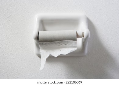 Empty Toilet Paper Roll On White Wall