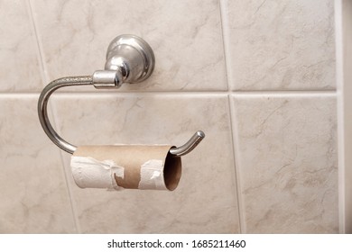 An Empty Toilet Roll On The Holder