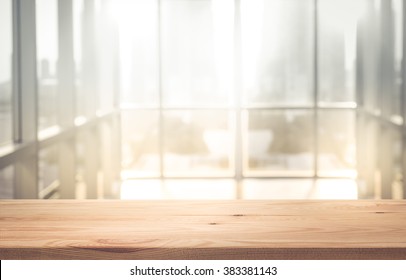 Empty the top of wood table with blur sunlight in window wall building background.for product display and presentation