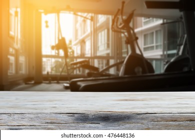 Empty Top Wood Table And Blur Fitness Gym Background .Product Display Template
