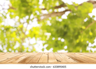 Empty top wooden table and blurred green nature bokeh background - Shutterstock ID 633890405