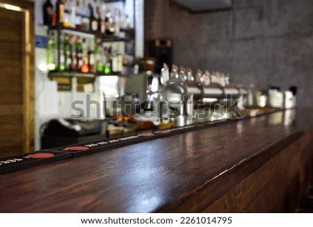 Empty the top of wooden table with blurred counter bar and bottles Background for your product display
