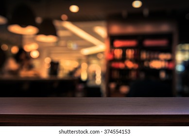 Empty top of wooden table or counter on cafeteria, bar, coffee shop background. For product display - Shutterstock ID 374554153