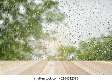 Empty Top Wooden Table On Drops Of The Rain On Blurred Green Nature