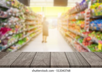 Empty top wooden table and sunny blurred shopping supermarket background. for product display