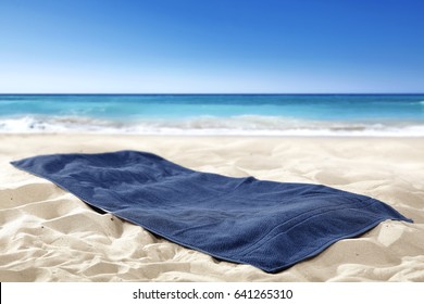 Empty towel on sand and free space 