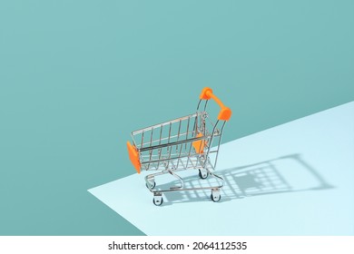 Empty toy cart, supermarket shopping, consumerism.